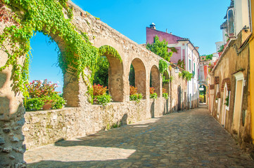 Fototapeta na wymiar old european street with stone wall