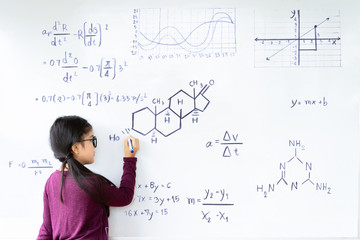 Beautiful girl writing on a blank whiteboard,education and school concept.