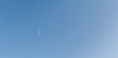 Blue Sky with a flying airplane