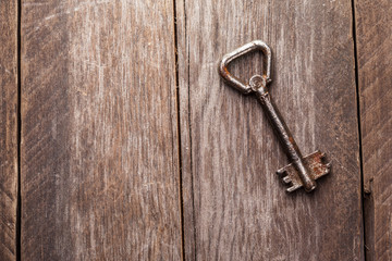 old keys on a brown wooden background