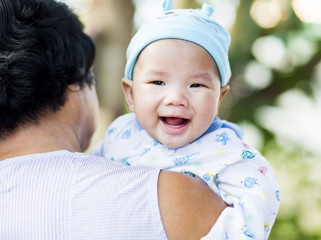 Thai baby in grandmother arm, chiangmai Thailand