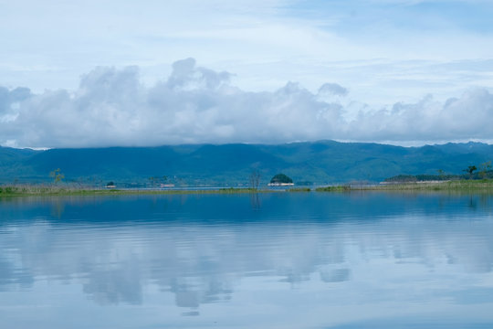 Mountain and Lake with reflex in the water scenery beautiful view with blue sky and clouds at Kanchanaburi