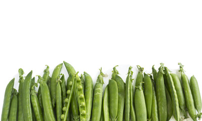 Green peas on a white background. Green peas at border of image with copy space for text. Fresh green peas on a white background.