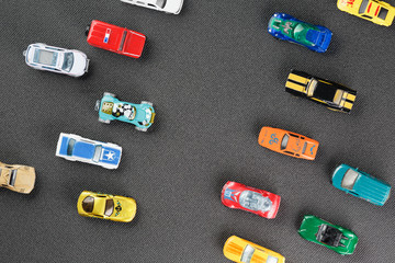 Colorful automotive toys. The apartment was lying, on a gray background