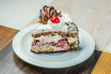 Slice of cake with cherries and strawberries