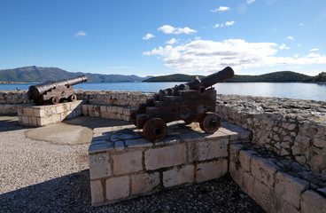 Fototapeta na wymiar Old cannon at old fortress in medieval town Korcula in Croatia 