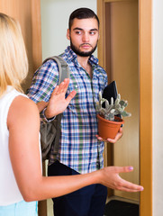 Young couple separating after quarrel .