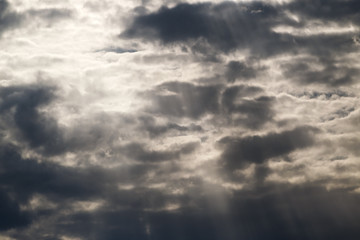 stormy grey sky with tiny sun rays trying to get through it. Element of design. Free space for text