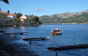 Fototapeta premium Seafront view at picturesque medieval Dalmatian town Korcula, Croatian culture and historic destination.