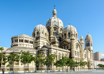 Three-quarters rear view of the cathedral of Marseille, Sainte-Marie-Majeure also known as La Major, a neo-byzantine style catholic building achieved in 1893, showing cupolas, chapels and turrets. © olrat