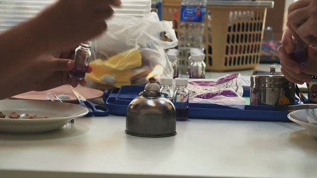 The researchers burning a test bottle for further analysis in food laboratory.