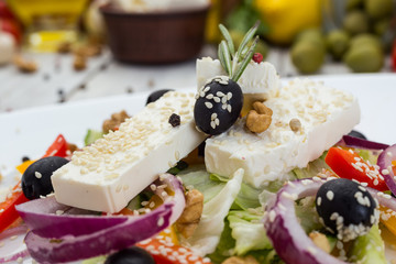 Greek salad with fresh vegetables, feta cheese and black olives