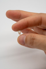 Mother hand holding milk teeth. Childhood healthcare