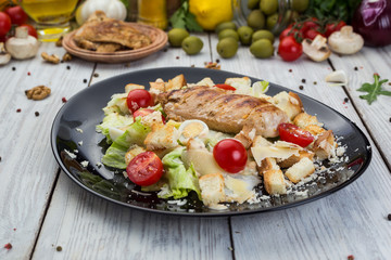Healthy Grilled Chicken Caesar Salad with Cheese, Croutons and Cherry Tomatoes