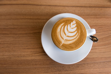Flat white coffee on wooden table, Top view