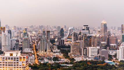 Fototapeta na wymiar Aerial view of Bangkok modern office buildings, condominium in Bangkok city downtown at the dusk. With city and traffic lights.