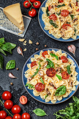 Italian pasta with sauce, cherry tomatoes, basil and parmesan cheese. Delicious pasta plate. Vegan pasta. 