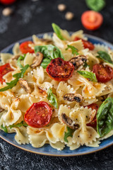 Italian pasta with sauce, cherry tomatoes, basil and parmesan cheese. Delicious pasta plate. Vegan pasta. 