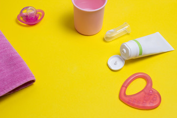 Baby toothbrush accessories for baby, toothpaste and brush on a yellow background for the little ones