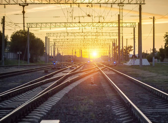 Fototapeta na wymiar Branching of railways against the background of a bright sunset