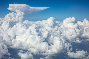Naklejka na ściany i meble Cloudy sky background. View out of an airplane window.