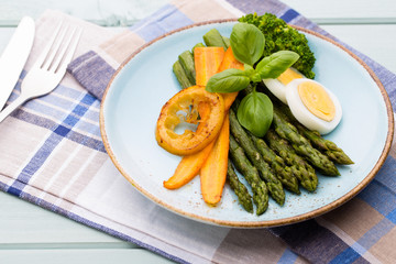 Fried asparagus with broccoli and lemon and carrot.