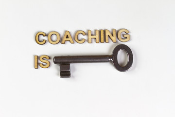 Coaching is key made with wooden letters and old key