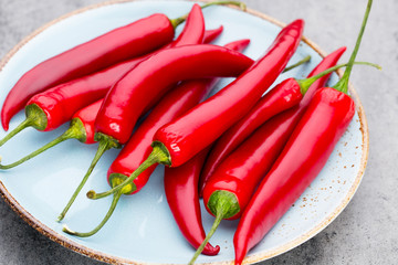 Chili cayenne pepper on grey background.