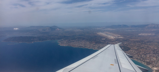 Plane over Athens, Greece airport. View out of airplane window.