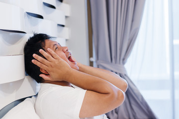 Obraz na płótnie Canvas Man in bed with headache after wake up.