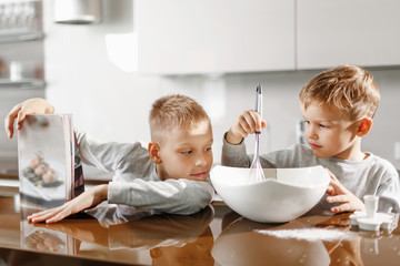 two little brothers help mom prepare delicious and healthy breakfast