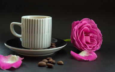 Obraz na płótnie Canvas coffee with pink rose on dark leather surface