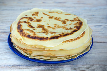Fresh pancakes on the plate. Pancakes close-up on wooden background