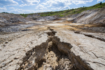 Fototapeta na wymiar Flooded open pit quarry ore clay mining with amazing terricons heaps scour and washouts