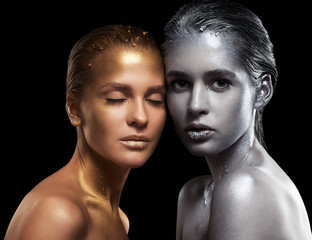 Beauty portrait of young gorgeous women. Golden and silver girls on black background