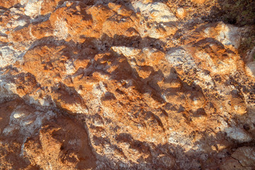 Uneven Red dry soil with fragments of saline soil