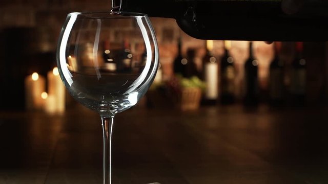 Wine expert pouring red wine in a glass
