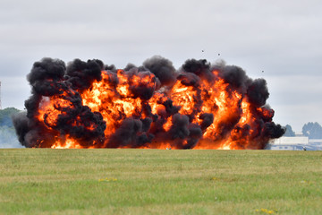 An explosion at RAF Fairford during a simulated ground attack. Orange flames and debris can be seen...
