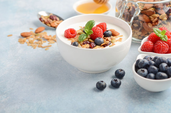 Homemade granola with yogurt and fresh berries, healthy breakfast concept, selective focus, copy space.