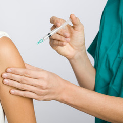 Nurse putting an injection in the arm