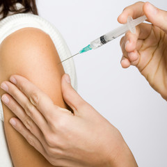 Nurse putting an injection in the arm