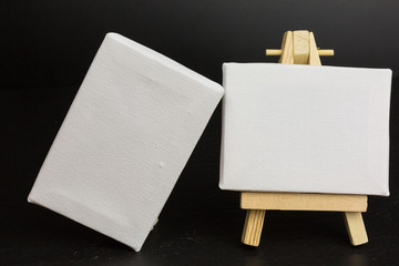 blank canvas on wooden easel with copy space