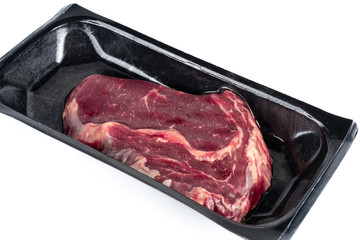 Raw steak in plastic pack.