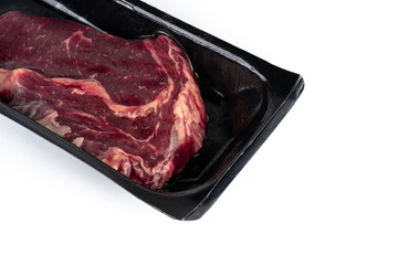 Raw steak in plastic pack.