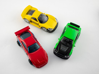 Three toy cars on a white background