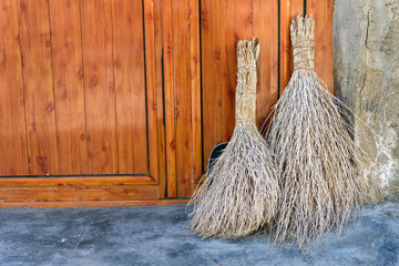 Brooms near the door in rock village Kandovan. Iran