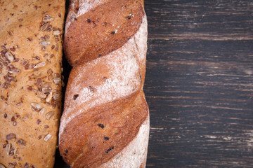 Fresh bread on wooden background. Top view with copy space