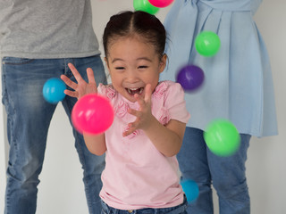 Fototapeta na wymiar young Asian Kid playing colorful ball.