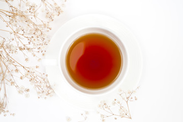 Cup of tea with flowers isolated on white background