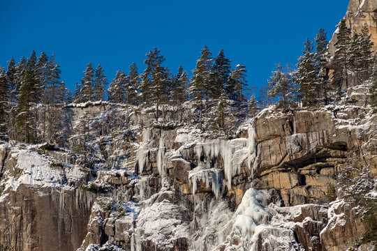 Icicle rock formation canyon trees sun